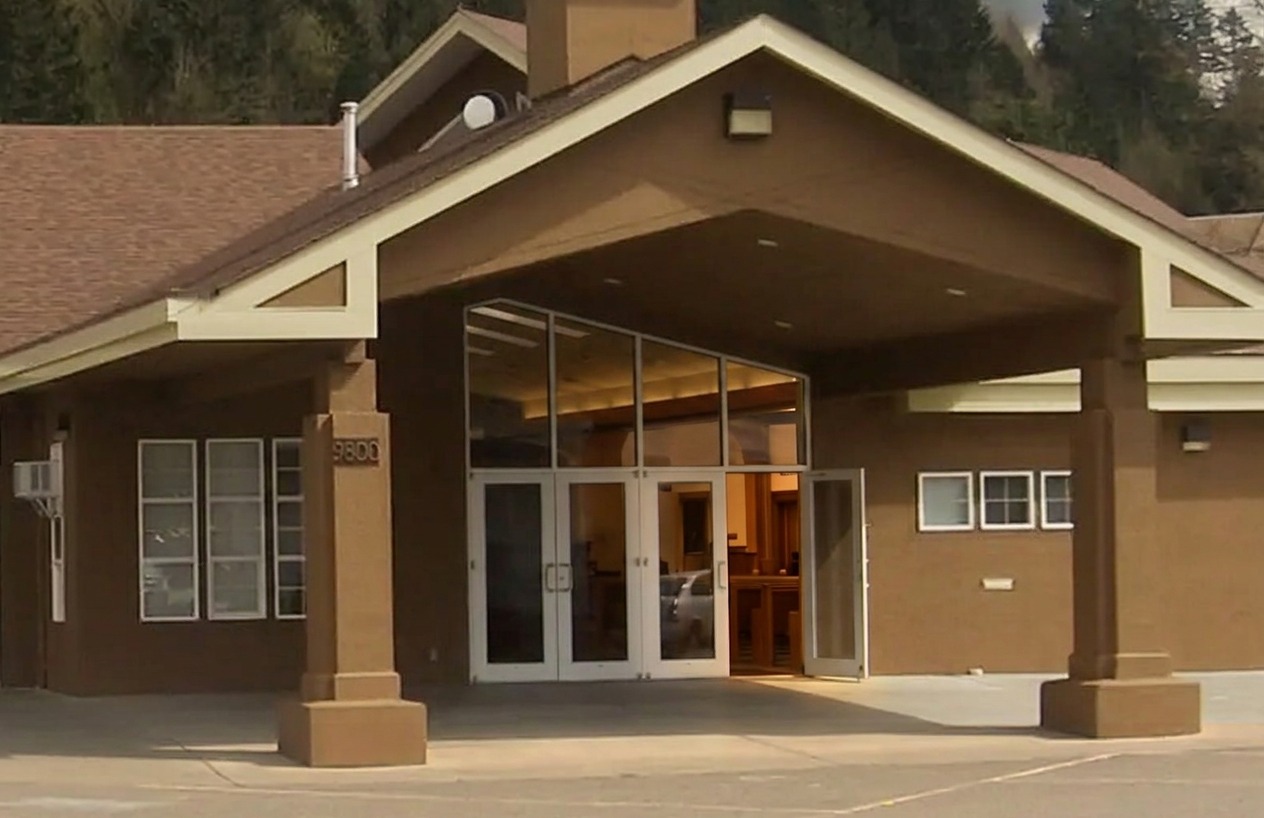 The covered entrance of Cornerstone's current building, one glass door standing open