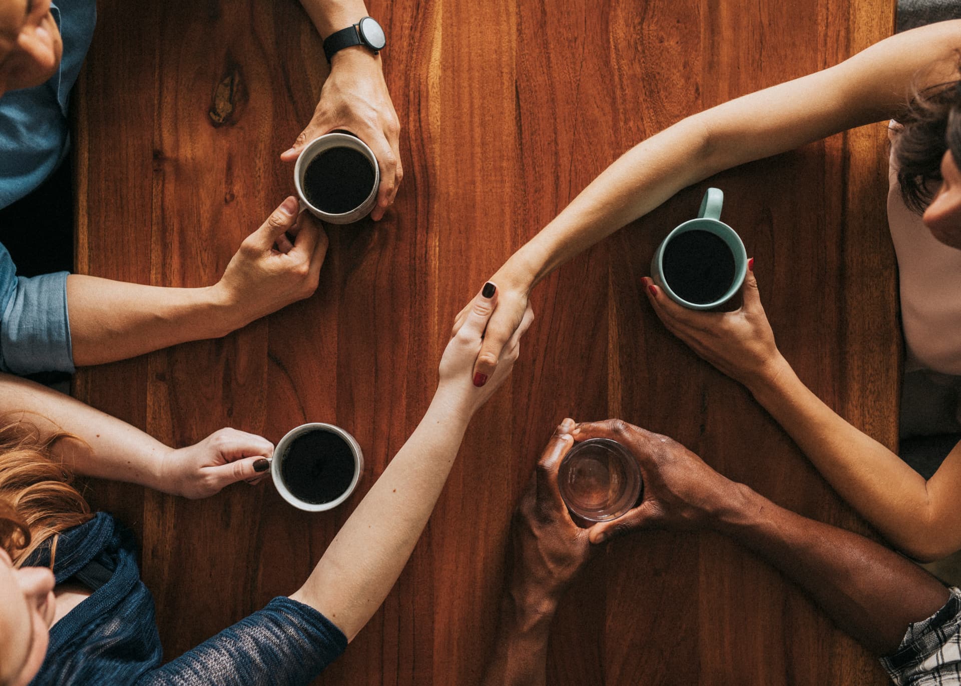 People gathered around a table with coffee